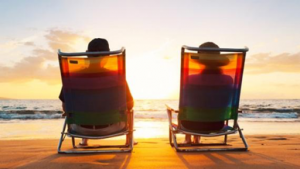 couple sitting in beach chairs overlooking the water