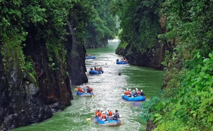 people rowing in a valley