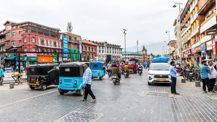 Traffic zips around Srinagar's central plaza, Lal Chowk (