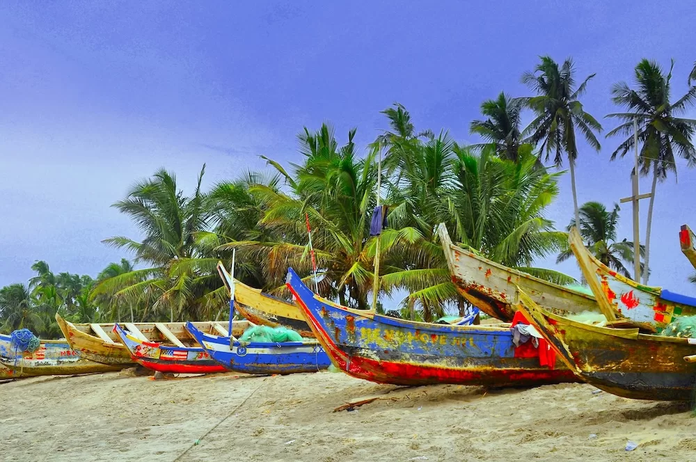 Pirogue boats line that Ghanan beachside.