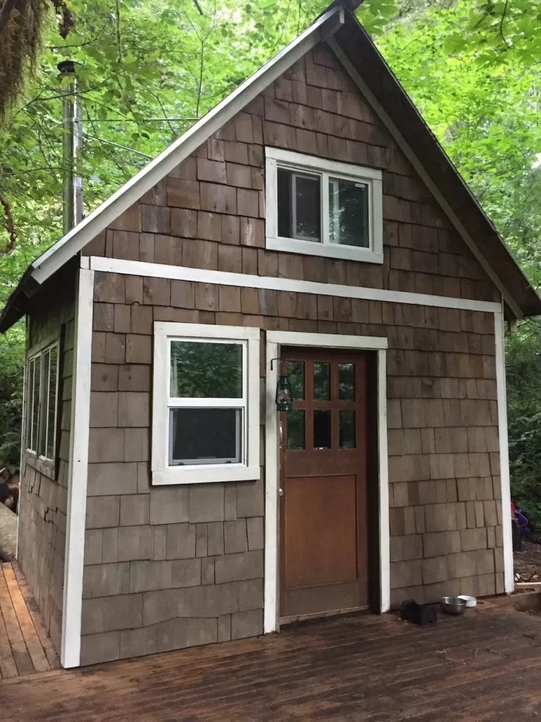 The exterior finished with fresh paint, stain, new shingles, lantern hook, boot scraper, and new roof