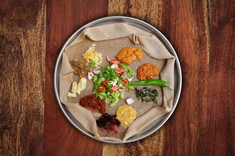 Sharing injera in Ethiopia is a sign of care, connection, and togetherness.