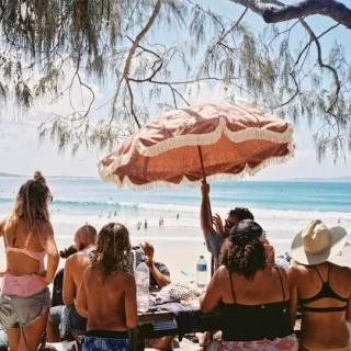 Every day life unfolds on Australia’s golden sands. Photo courtesy of Raygar He_Unsplash.